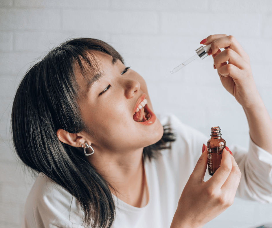 A women prepares to give herself medication via the sublingual route (under her tongue). 