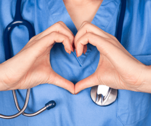 A doctor making a heart with their hands