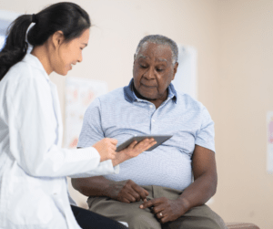 A female doctor consults with a male patient